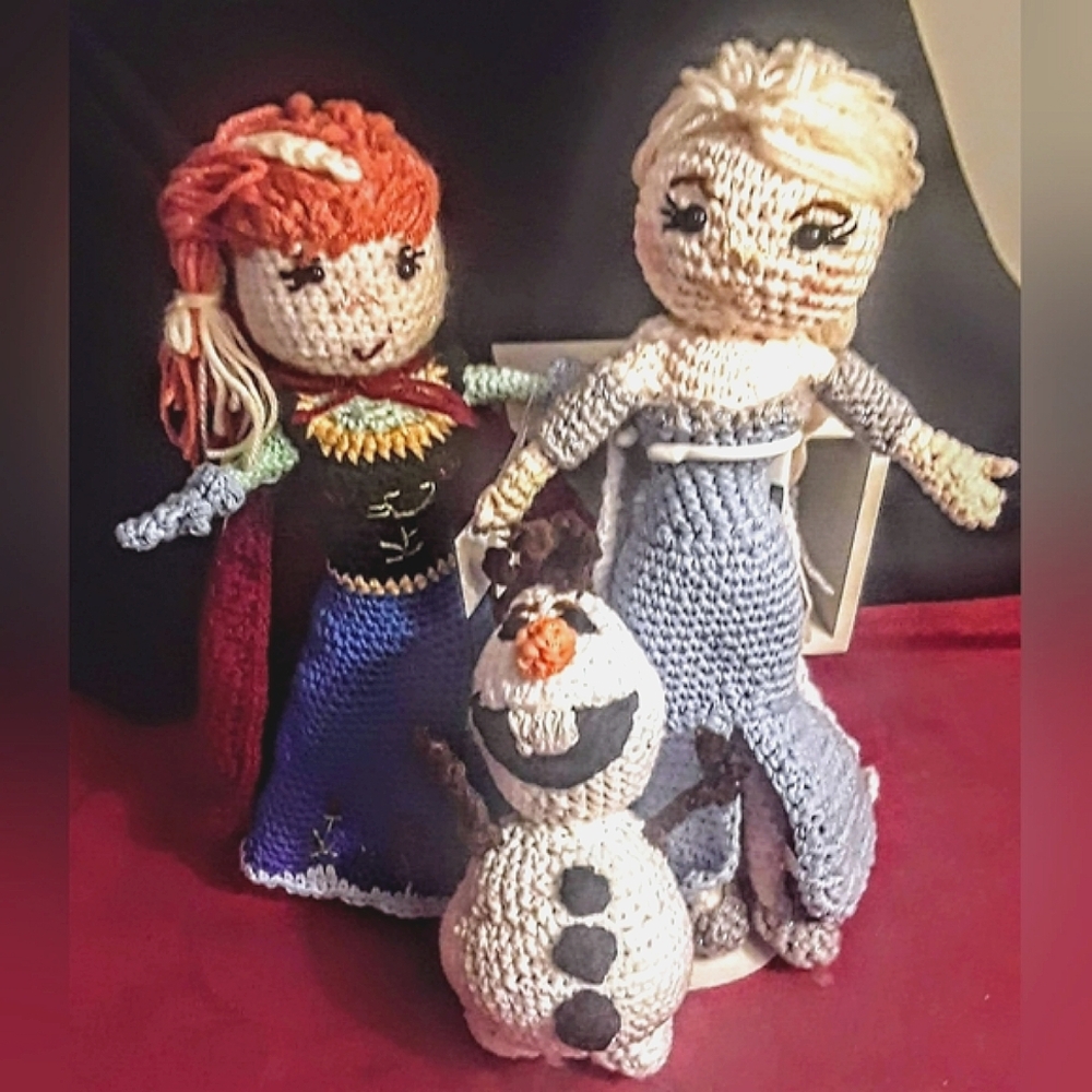 Hand crocheted, Frozen's inspired dolls, Elsa, Anna, and Olaf. Includes  stand,